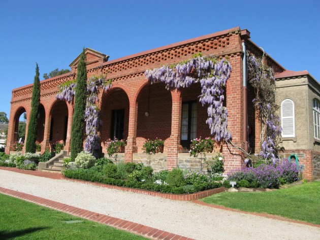 The house is a distinctive Mediterranean character, open brickwork parapet in soft terracotta colours.